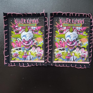 May include: Two square patches with a black background and a pink stitched border. Each patch features a colourful graphic of a clown with the text "Killer Klowns From Outer Space". The patches also have the text "Alien Bozos With An Appetite For Close Encounters".