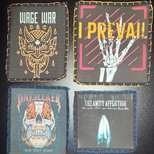 May include: Four square patches with embroidered edges. The patches feature band logos: "WAGE WAR" with a demon, "I PREVAIL" with a skeleton hand, "DAYSEEKER" with a skull, and "THE AMITY AFFLICTION" with a ghost.