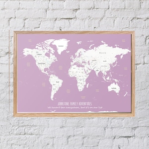 May include: A light purple world map with white countries and text. The map is framed in a light wood frame. The text at the bottom reads "JOHNSTONE FAMILY ADVENTURES We haven't been everywhere, but it's on our list."