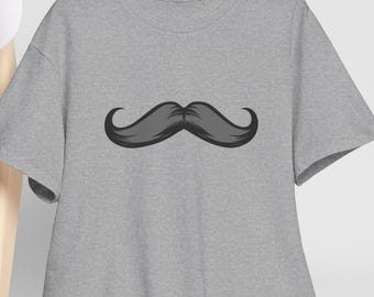 May include: A gray t-shirt featuring a large, stylized mustache graphic in shades of gray and black. The mustache is centered on the shirt, which is hanging on a wooden hanger. The shirt has short sleeves and a crew neck.