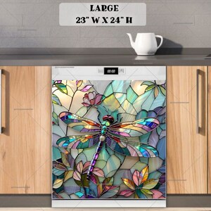 May include: A colourful stained glass dragonfly design on a white dishwasher door. The design features a dragonfly with blue, green, red, and yellow wings, surrounded by flowers and leaves. The dishwasher is 58.4 cm wide and 61 cm high.