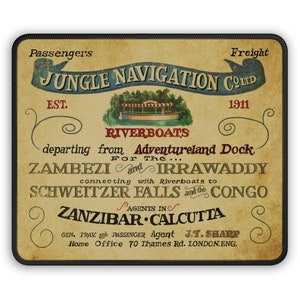 May include: Vintage-style poster advertising Jungle Navigation Co. Ltd. riverboat tours. The poster features a brown background with a yellow banner that reads "Jungle Navigation Co. Ltd." and a smaller banner that reads "Riverboats". The poster also includes text that says "Est. 1911" and "Departing from Adventureland Dock for the Zambezi and Irrawaddy, connecting with riverboats to Schweitzer Falls and the Congo. Agents in Zanzibar, Calcutta. Gen. Trav. and Passenger Agent J.T. Sharp, Home Office 70 Thames Rd. London, Eng."