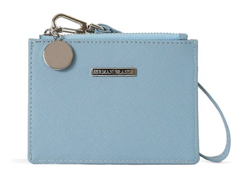 May include: A light blue leather card holder with a silver zip, a silver charm, and the text "Sherman Brands" on the front.