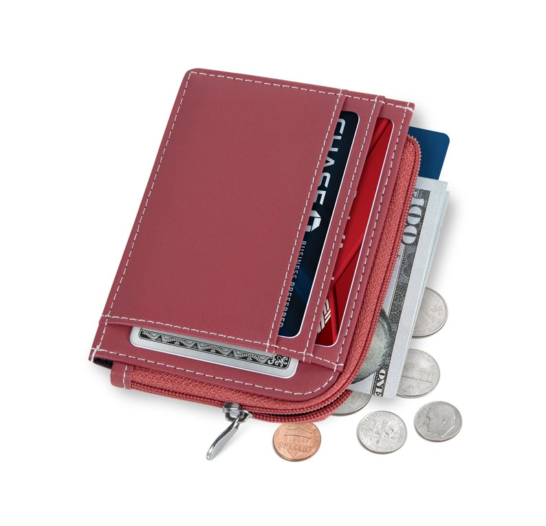 May include: A red wallet with white stitching, a zipper, and a silver zipper pull. The wallet is open, revealing credit cards, cash, and coins. The wallet is approximately 4 inches wide and 5 inches tall.