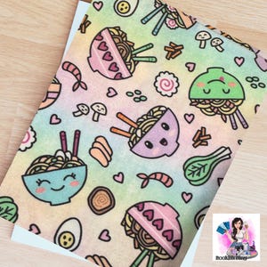 May include: A colorful, patterned fabric featuring cartoon ramen bowls, shrimp, mushrooms, and hearts on a pastel rainbow background. The design includes chopsticks, eggs, and other ramen ingredients. The overall theme is food and kawaii.