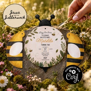 May include: A bee-shaped invitation card featuring yellow and black striped wings and a central circular panel with green foliage, small bee illustrations, and text reading Buzz On Over To Celebrate Our Little Honey, Matilda, Turning Two.