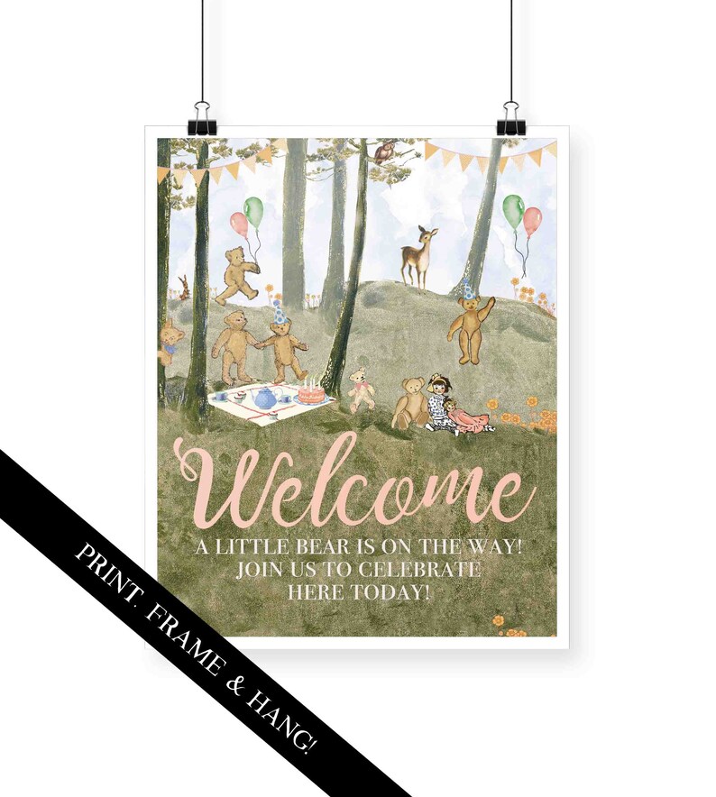 May include: A welcome sign for a baby shower with a woodland theme. The sign features a pink and green color scheme with a whimsical illustration of teddy bears having a picnic in the woods. The text on the sign reads "Welcome, A little bear is on the way! Join us to celebrate here today!"