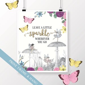 May include: A white printable art print with a gold glitter quote that says "Leave a little sparkle wherever you go". The quote is surrounded by a floral border and illustrations of fairies on mushrooms.