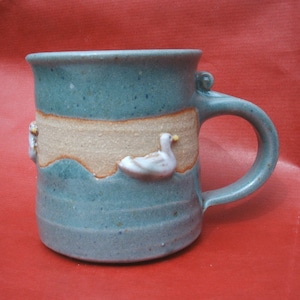 Handmade stoneware mug with raised duck design. 9cmx8cm