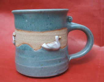 Handmade stoneware mug with raised duck design. 9cmx8cm
