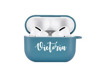 May include: A teal blue silicone case for AirPods with the name "Victoria" printed in white on the front.