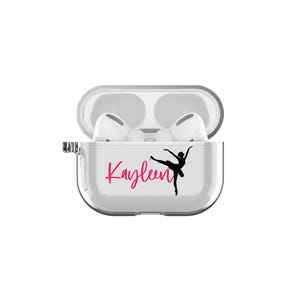 May include: A white clear plastic case for wireless earbuds with a pink and black silhouette of a ballerina and the name "Kayleen" in pink lettering.