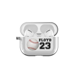 May include: White protective case for wireless earbuds with a baseball and the name "FLOYD 23" printed on it.