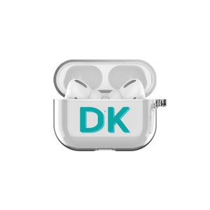 May include: A clear plastic case for wireless earbuds with a teal blue "DK" monogram on the front.