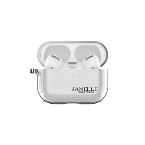 May include: A clear plastic case for wireless earbuds with a white interior. The case has a small blue light on the front and the name "JANELLE" and the phone number (888) 222 5698 printed on the bottom.