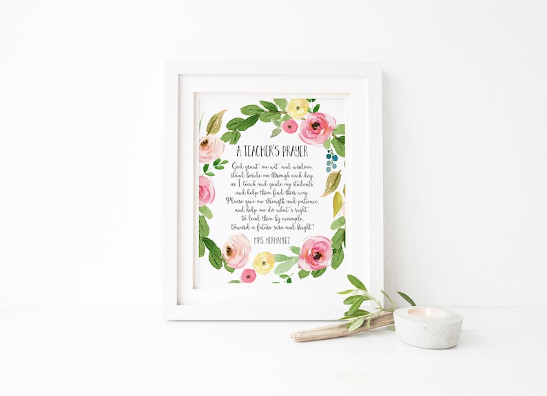 May include: A printable art print with a floral wreath design. The print features a poem titled "A Teacher's Prayer" with the text: "God grant me wit and wisdom, stand beside me through each day as I teach and guide my students and help them find their way. Please give me strength and patience, and help me do what's right, to lead them by example, toward a future wise and bright!" The print is signed "Mrs. Hernandez".