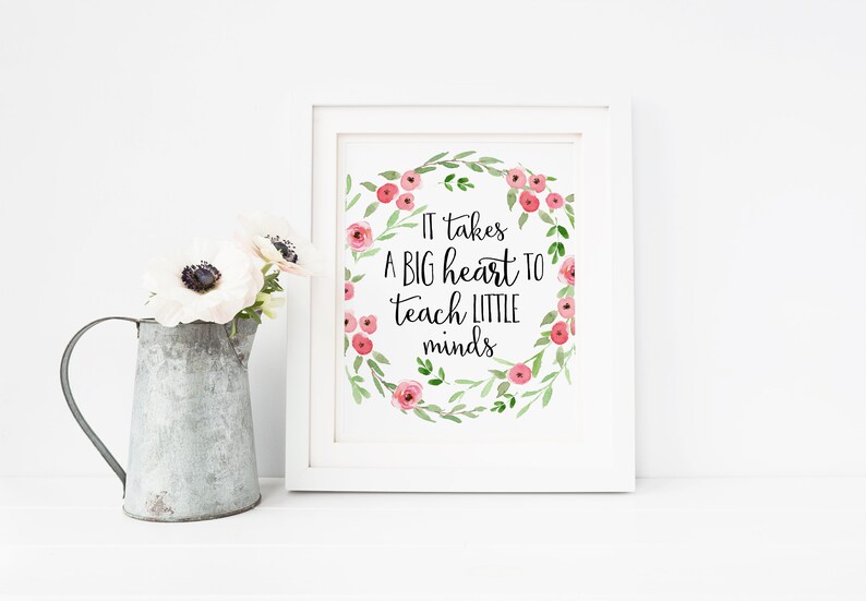 May include: White framed print with a floral wreath and the text "It takes a big heart to teach little minds".