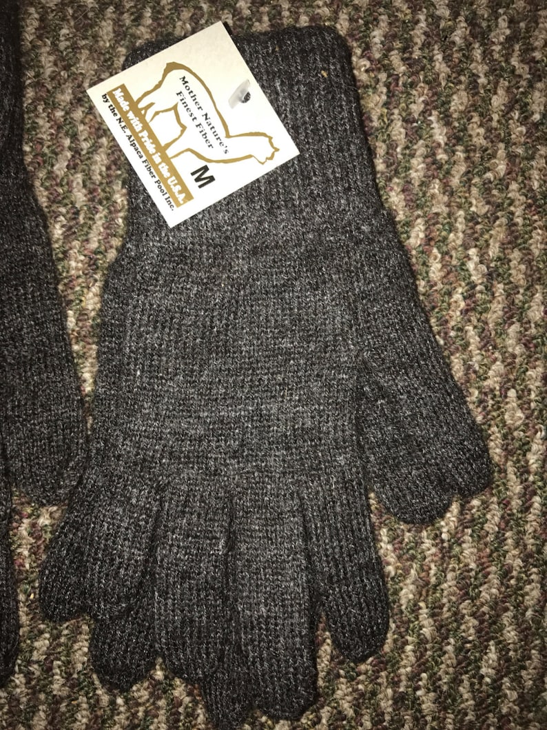 May include: Gray alpaca fiber gloves with a tag that reads "Mother Nature's Finest Fiber M Made with Pride in the U.S.A. by the N.E. Alpaca Fiber Pool Inc."