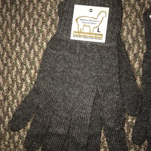 May include: A pair of brown alpaca knit gloves with a tag that reads "Mother Nature's Finest Fiber" and "Made with Pride in the U.S.A. by the N.J. Alpaca Fiber Pool Inc."