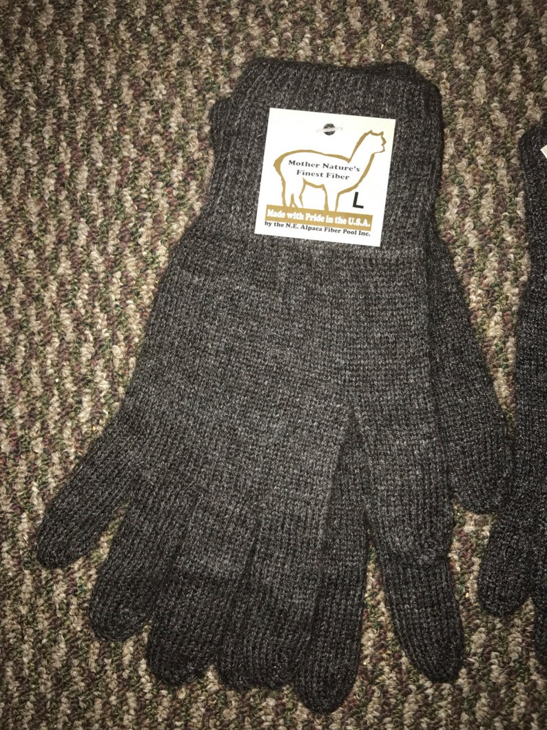 May include: A pair of brown alpaca knit gloves with a tag that reads "Mother Nature's Finest Fiber" and "Made with Pride in the U.S.A. by the N.J. Alpaca Fiber Pool Inc."