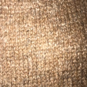 May include: Close-up of a brown carpet with a soft, fuzzy texture.