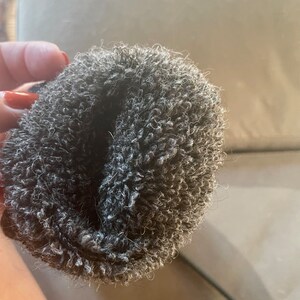 May include: A gray fuzzy scrunchie for hair.
