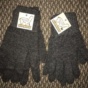 May include: A pair of brown alpaca wool gloves with a tag that reads "Mother Nature's Finest Fiber" and "Made with Pride in the USA". The tag also includes the size, either "L" or "M".