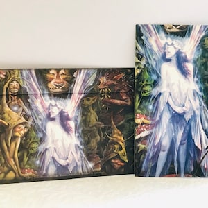 May include: A colourful greeting card featuring a fairy with iridescent wings and a crown of flowers. The fairy is surrounded by woodland creatures and plants. The card has the text "Fairy Tree Greetings, Keene, NH 03431, World Wide Web: Cardisle.com".