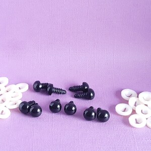 May include: A set of black plastic safety eyes with washers for crafts. The set includes 6 pairs of eyes and 12 washers.