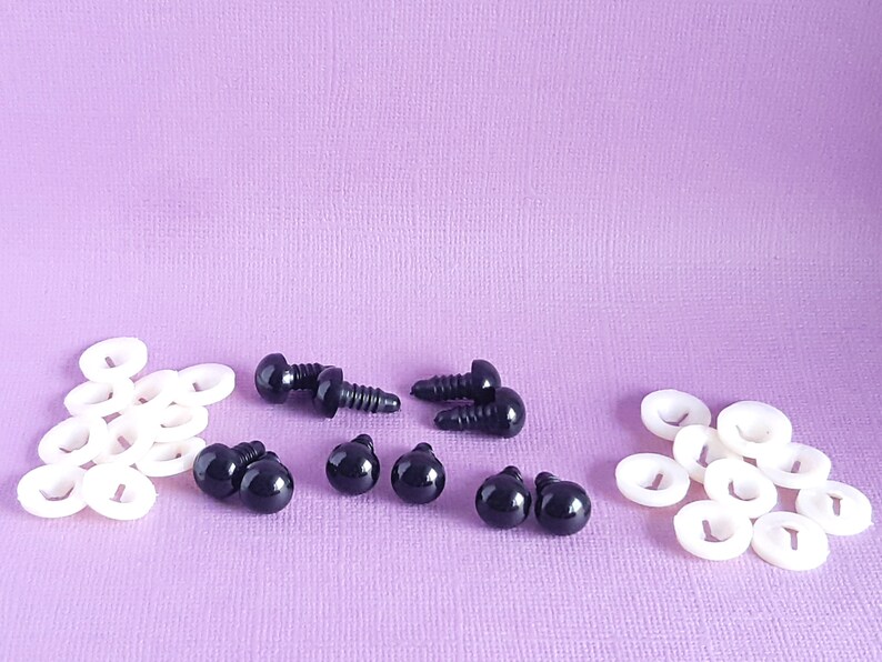 May include: A set of black plastic safety eyes with washers for crafts. The set includes 6 pairs of eyes and 12 washers.