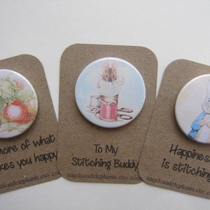 May include: Three round brown paper cards with white circles containing images of a rabbit, a mouse, and a squirrel. The cards have text that reads "Do more of what makes you happy", "To My Stitching Buddy", and "Happiness is stitching".