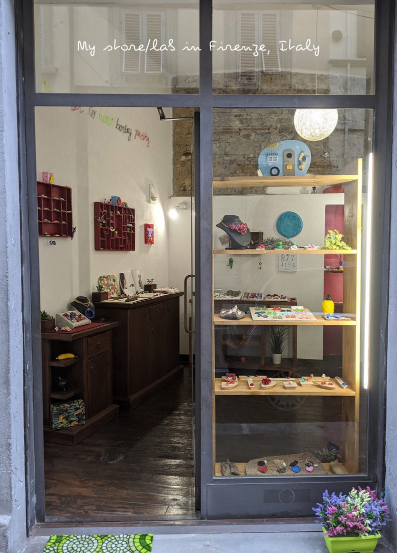 May include: A shop window display in Florence, Italy, featuring colourful jewellery and accessories. The shop is called "My store/lab's in Firenze, Italy".