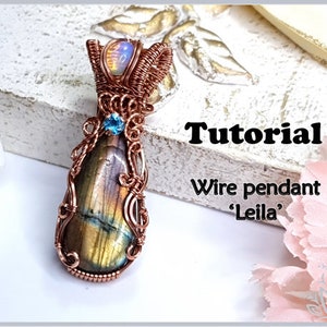 May include: Copper wire wrapped pendant featuring a large iridescent labradorite gemstone and a smaller blue gemstone. The pendant is labeled "Tutorial Wire pendant 'Leila'".