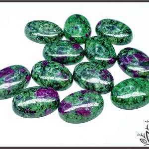 May include: A group of ten oval-shaped green and purple gemstones. The stones are smooth and polished, with a variety of shades of green and purple.