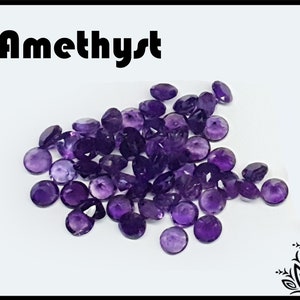 May include: A collection of small, round, faceted purple amethyst gemstones scattered together. The word Amethyst is printed in a bold, black, sans-serif font in the upper left corner, and a black floral graphic is in the bottom right corner.