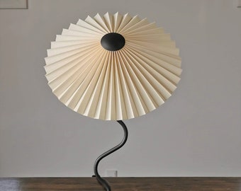 Clip on shade: Tilting Eclipse, pleated lampshade, available in several sizes, for table lamps, floor lamps or wall lights. Danish design.