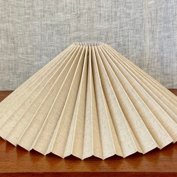 Clip on shade: Sand coloured linen mix, pleated lampshade, available in two styles, for table lamps/wall lights. Danish designed.