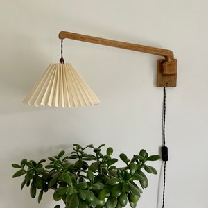 Danish handmade solid oak, wall swing light with a natural white chintz, pleated lampshade.