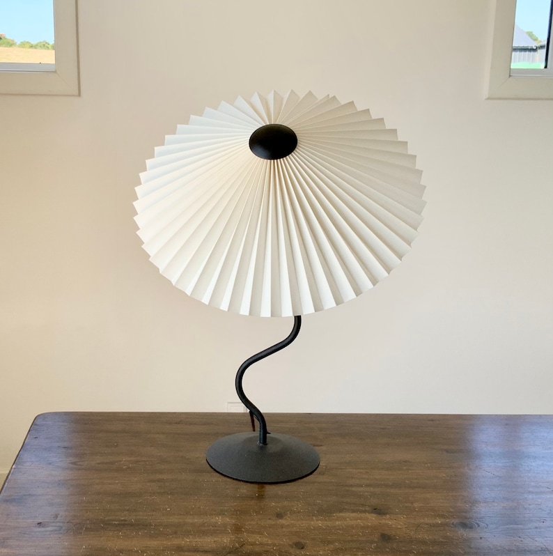 Clip on shade: Tilting Eclipse, pleated lampshade, available in several sizes, for table lamps, floor lamps or wall lights. Danish design. Ivory linen