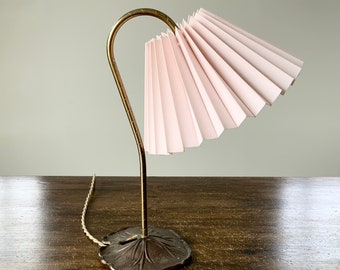 Art nouveau table lamp in bronze with swan neck and lily pad base. Baby pink linen, pleated lampshade.