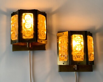 Pair of mid-century Vitrika, brass wall sconces with heavy, clear pressed champagne coloured glass.