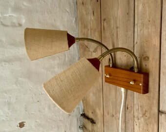 Swedish Mid-century double wall light / reading lamp in teak with flex arm / flexible brass necks and hessian lampshades.