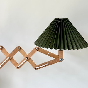 Danish designed beech wood accordion wall lamp with a new, Lekrazyhorse, pleated upper lampshade. Scandinavian retro interiors Olive green cotton