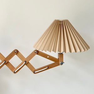 Danish designed beech wood accordion wall lamp with a new, Lekrazyhorse, pleated upper lampshade. Scandinavian retro interiors Cafe au lait linen