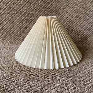 Clip on shade: Cream linen, pleated lampshade, available in two styles, for table lamps/wall lights. Danish designed. Classic
