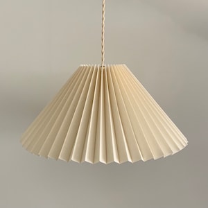Hanging shade: Cream linen MEDIUM EASTERN style pleated pendant / hanging shade, available in several sizes. Danish design.