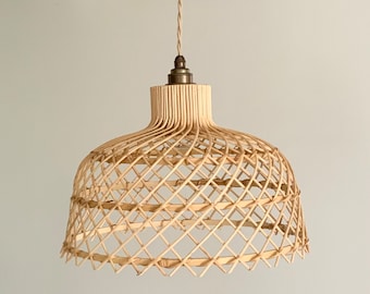 Natural wicker rattan ceiling pendant / light with jute cable and burnished brass fittings.