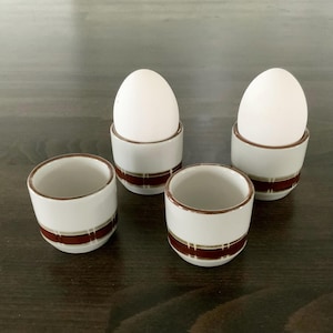 Set of four vintage Danish hand painted ceramic / pottery egg cups in earthy tones.