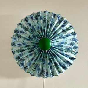 Danish designed, rosette / fan shaped, wall  light, with a knife pleated, floral blue lampshade with emerald green finial / centre.