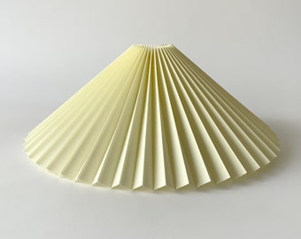 Clip on shade: Pale lemon chintz, pleated lampshade, available in two styles, for table lamps/wall lights. Danish design.